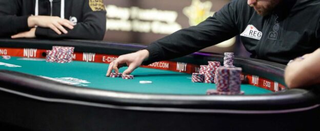 A poker player making a small bet.